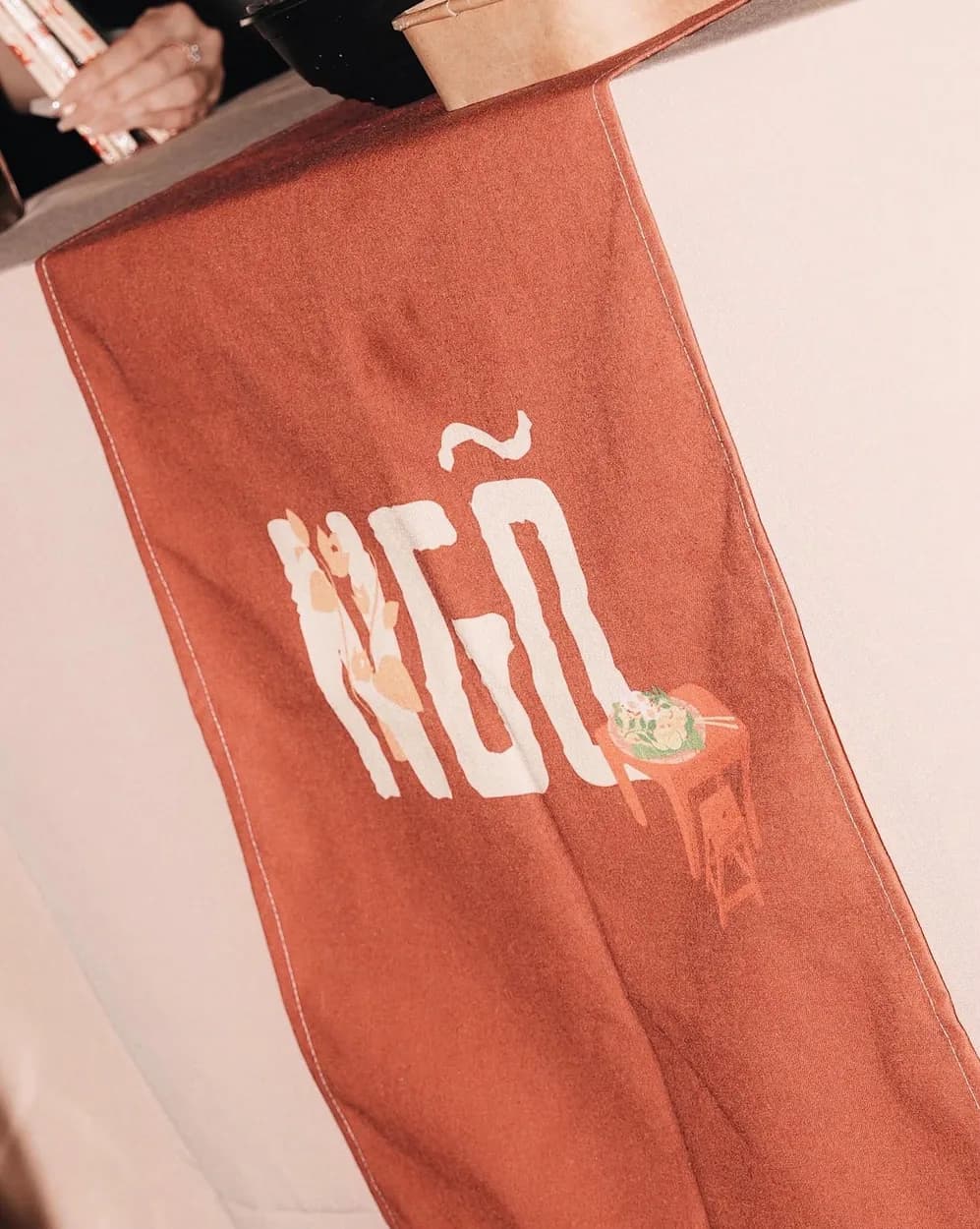 The Ngõ banner going up at a pop-up